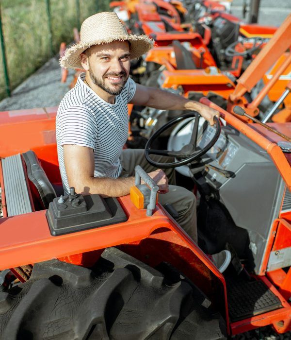 Agronomist choosing tractor at the agricultural shop